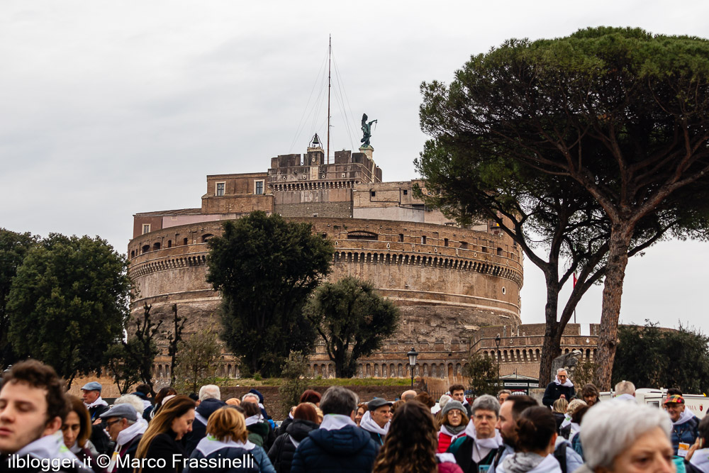 Castel Sant’Angelo a Roma con folla di visitatori in primo piano e la statua dell’Arcangelo Michele visibile sulla sommità della fortezza.